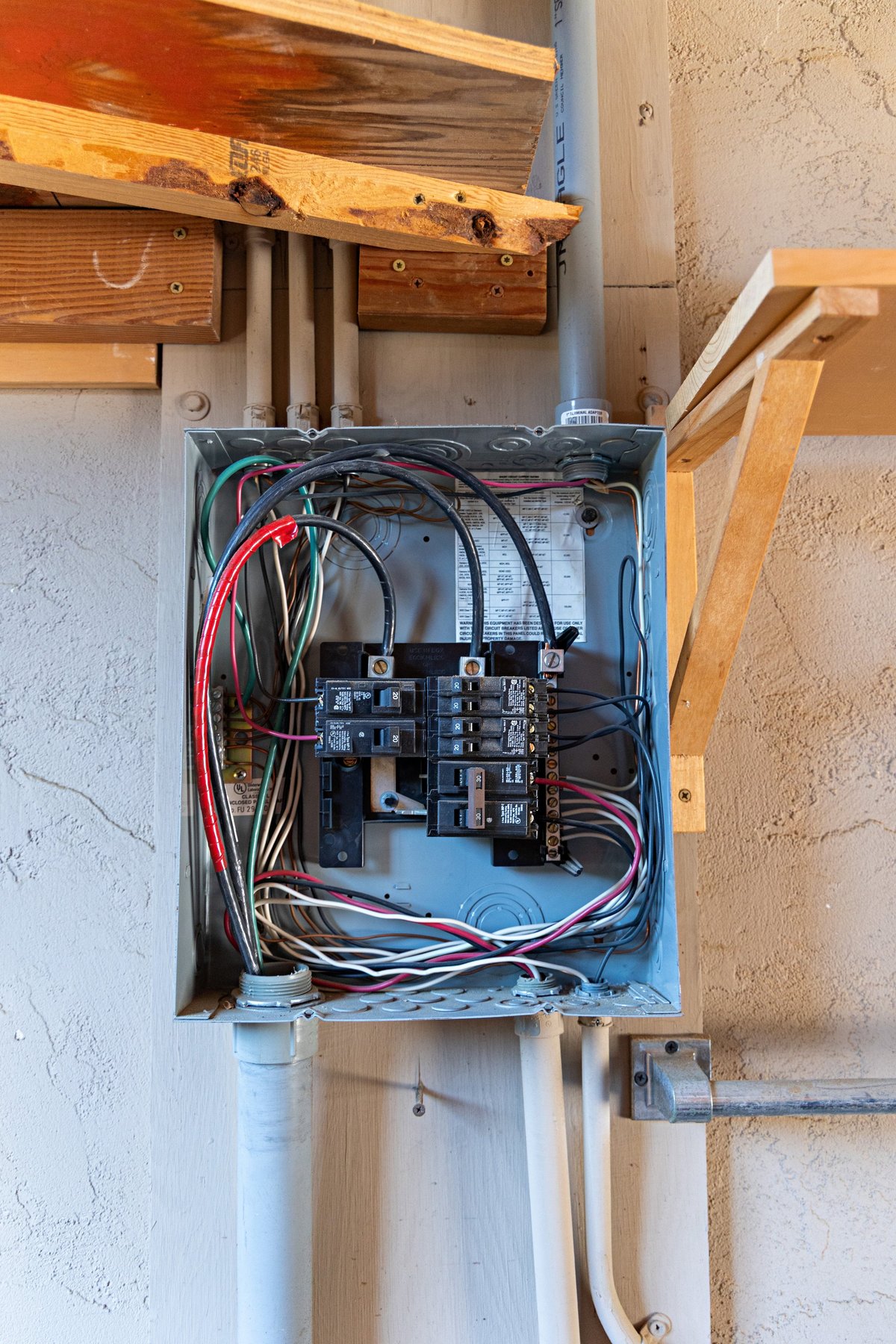 old electrical sub panel in a residential garage