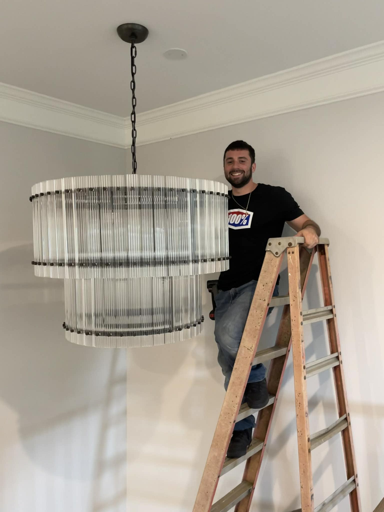 Nick Shapiro installing chandelier lighting in Cumming GA